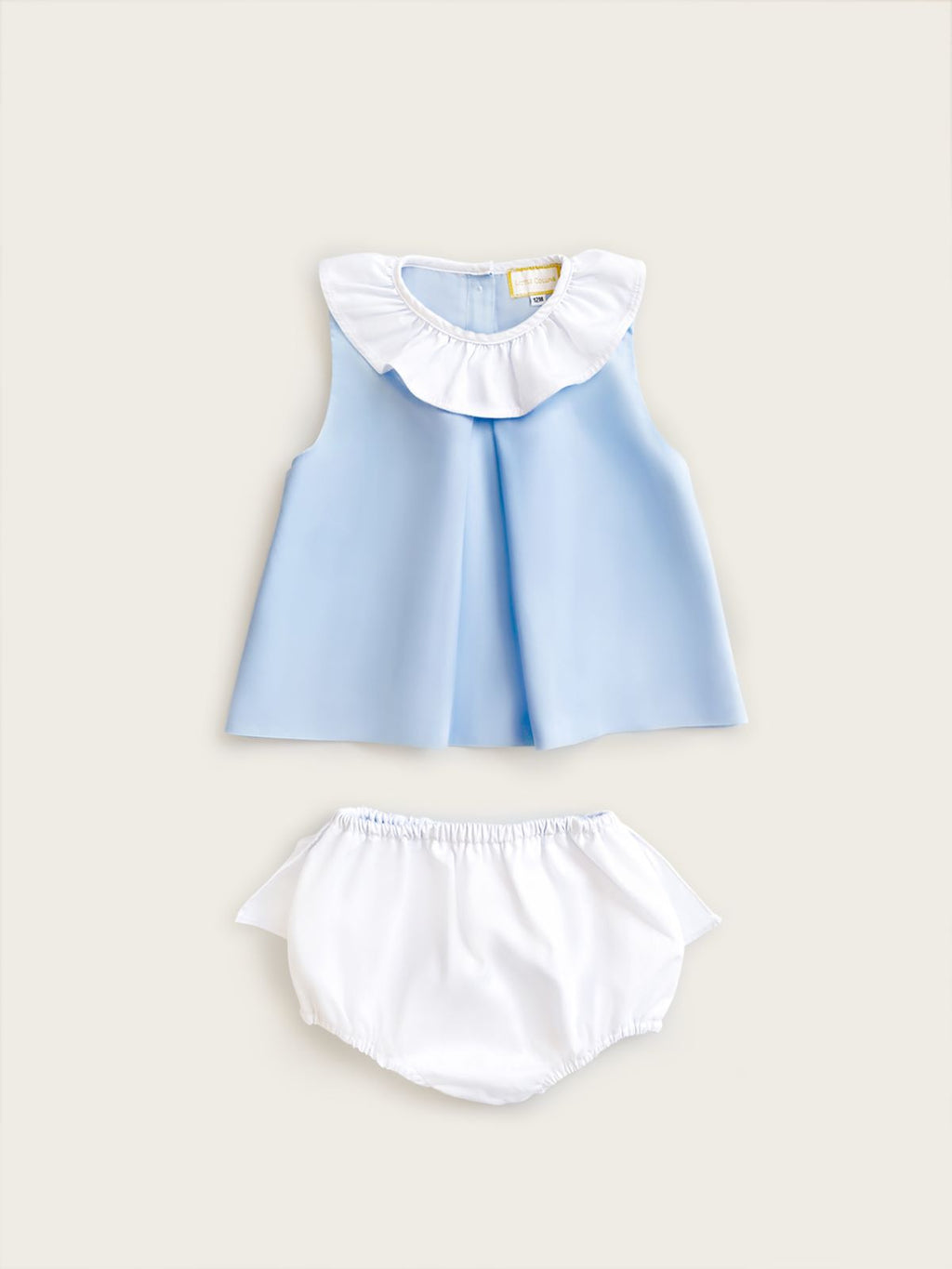 Little Collins Clothing two piece set for girls containing light blue top with white frill and white frilled bloomers front view
