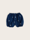Baby boy bloomer in a blue denim with white nautical anchors and ship's wheels rear view.