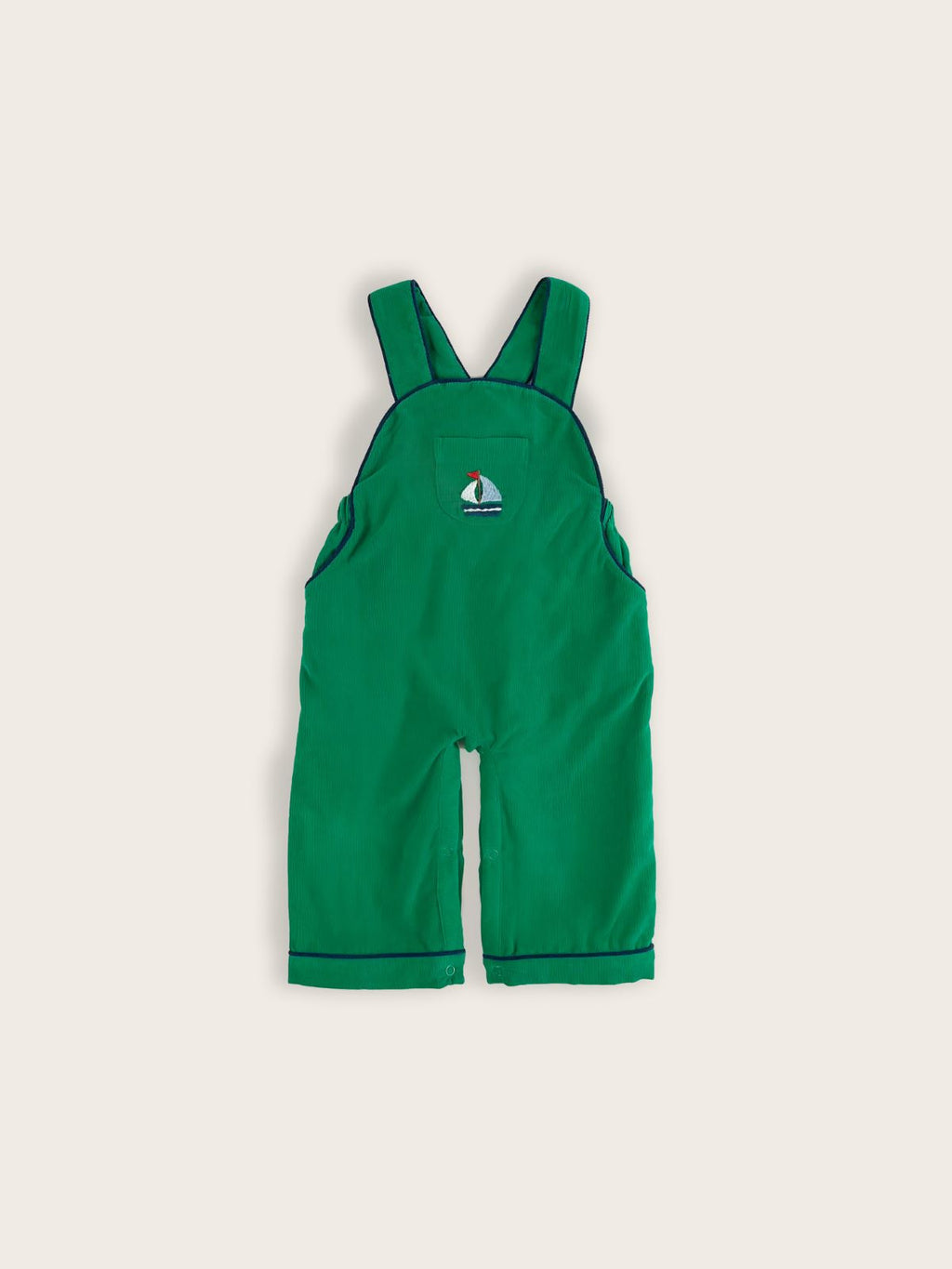 Green corduroy children's overalls featuring a front middle pocket with a blue sailboat embroidered.