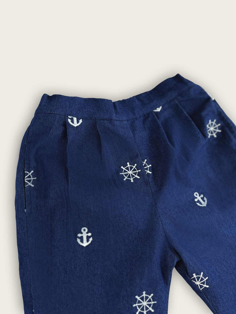 Boys trousers in a blue denim with white nautical anchors and ship's wheels motifs