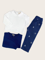 Boys trousers in a blue denim with white nautical anchors and ship's wheels motifs paired with white long sleeve collared shirt and blue merino wool jumper.