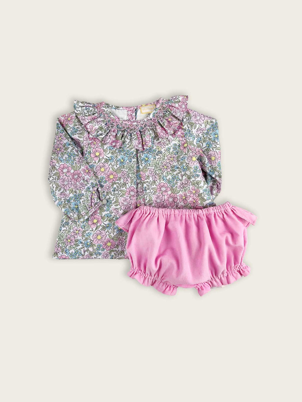 Floral baby and toddlers blouse with pink corduroy bloomers, featuring a frilled collar with hand smocking.